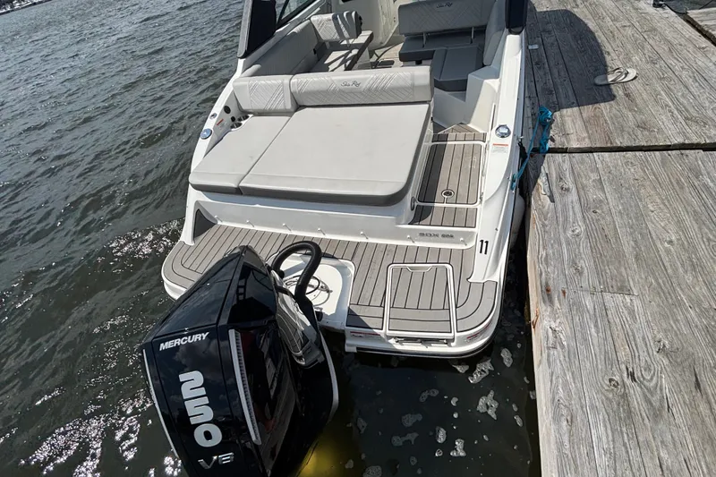Slide: The Image of 2025 Sea Ray SDX 250 Outboard docked, featuring spacious seating and Mercury V8 engine. - 8