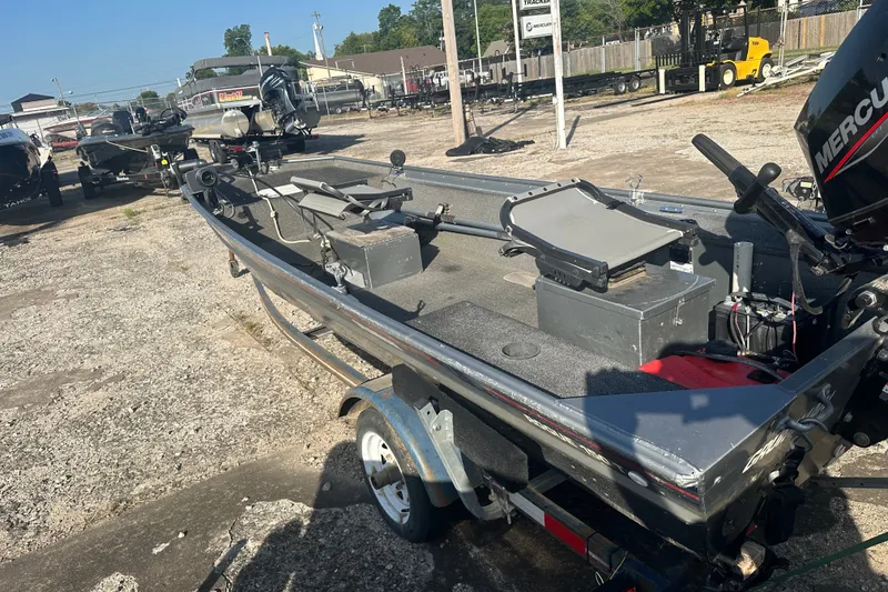 Slide: The Image of 1991 Grumman Rouge 150 T boat with Mercury engine on trailer in outdoor lot. - 11