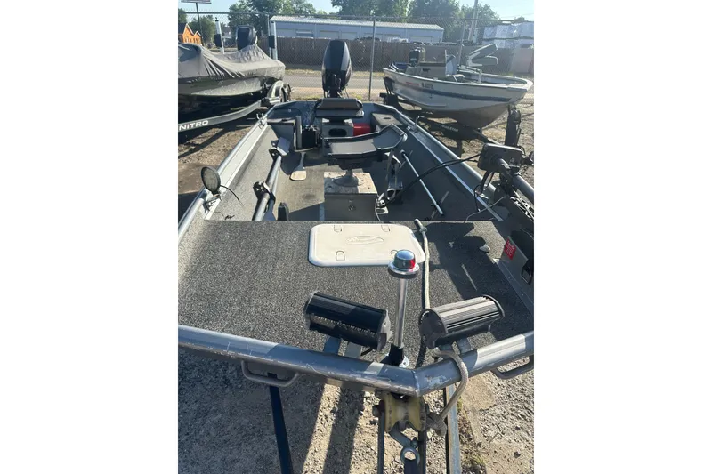 Slide: The Image of 1991 Grumman Rouge 150 T boat with fishing equipment, parked outdoors. - 8