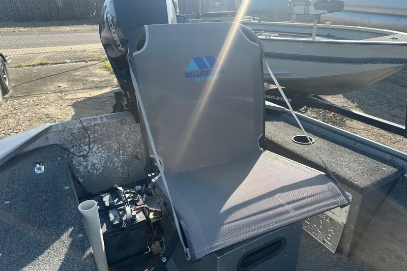 Slide: The Image of Grumman Rouge 150 T boat seat with motor, 1991 model, in sunlight. - 13