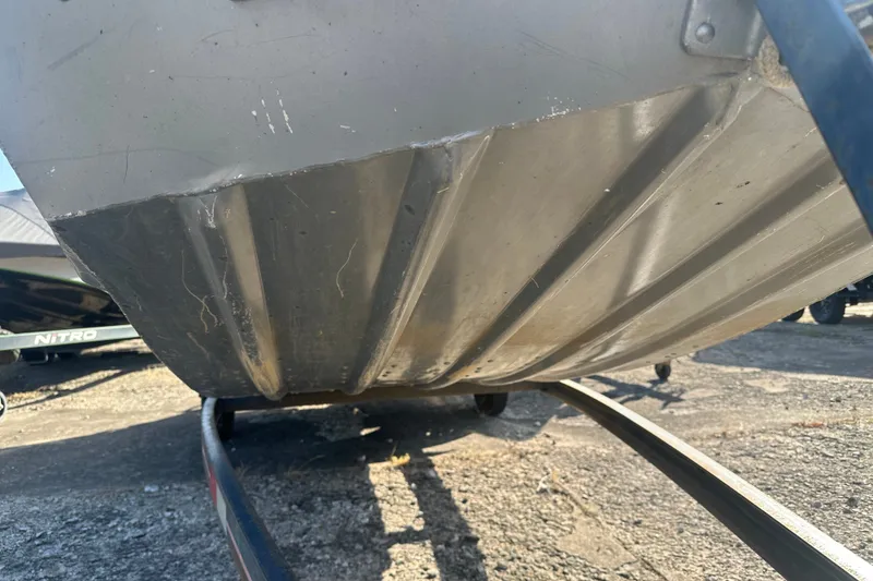 Slide: The Image of Underside view of a 1991 Grumman Rouge 150 T boat on a trailer. - 6