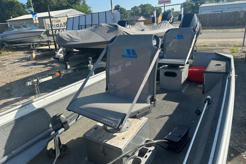 Slide: The Image of 1991 Grumman Rouge 150 T boat with seating and equipment, parked outdoors. - 16