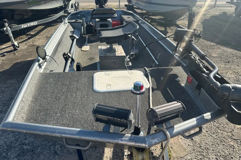 Slide: The Image of 1991 Grumman Rouge 150 T boat with fishing equipment and carpeted deck. - 7