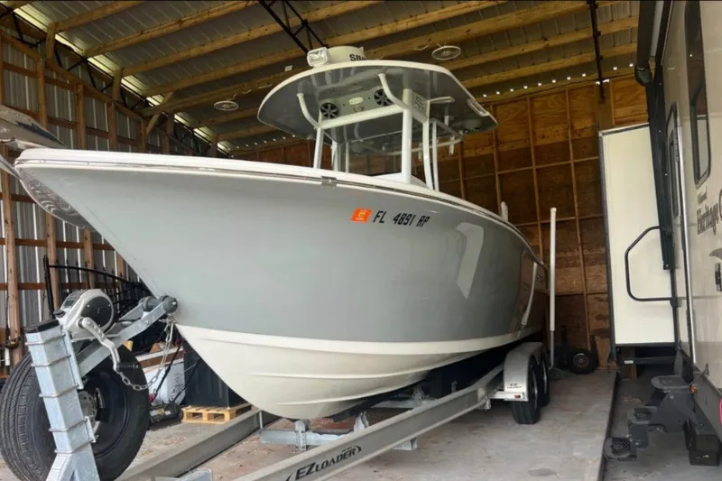 Slide: The Image of 2018 Sea Pro 239 Center Console boat on trailer in storage shed. - 1