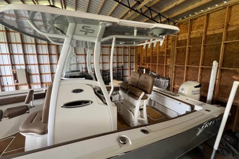 Slide: The Image of 2018 Sea Pro 239 Center Console boat in a wooden storage shed. - 3