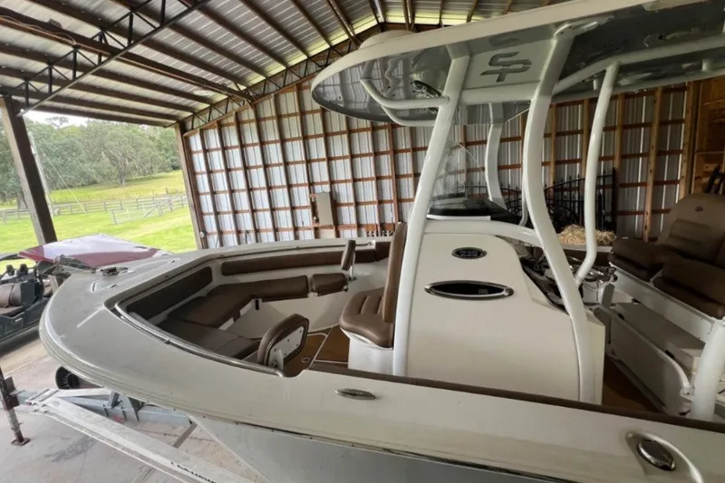 Slide: The Image of 2018 Sea Pro 239 Center Console boat in a covered storage area. - 4