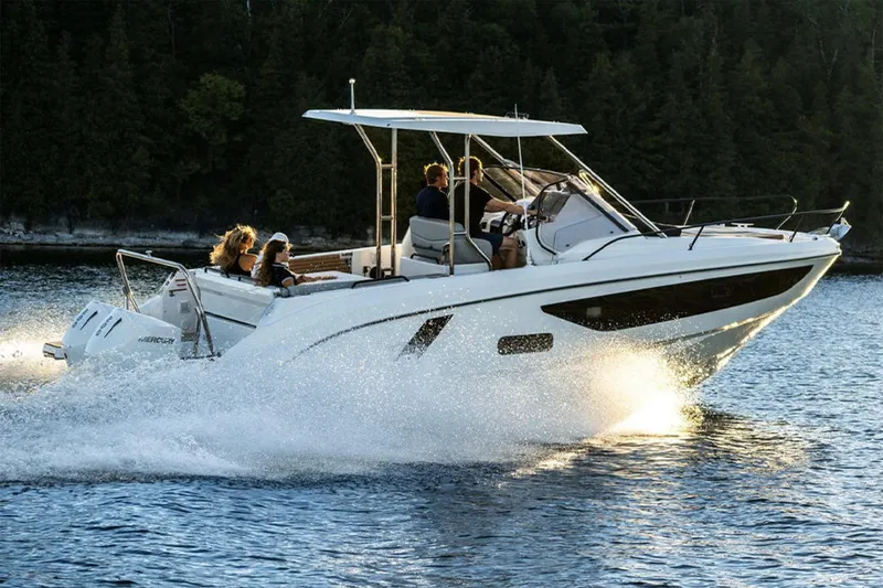 Slide: The Image of Manufacturer Provided Image: 2026 Beneteau Flyer 9 SUNdeck cruising on water with passengers, surrounded by trees. - 1