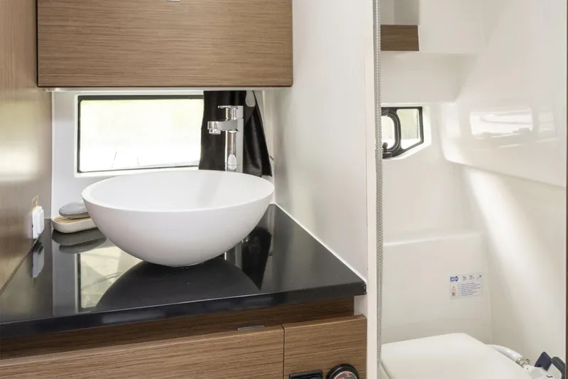 Slide: The Image of Manufacturer Provided Image: Modern bathroom interior of 2026 Beneteau Flyer 9 SUNdeck with sleek sink and wooden cabinetry. - 6