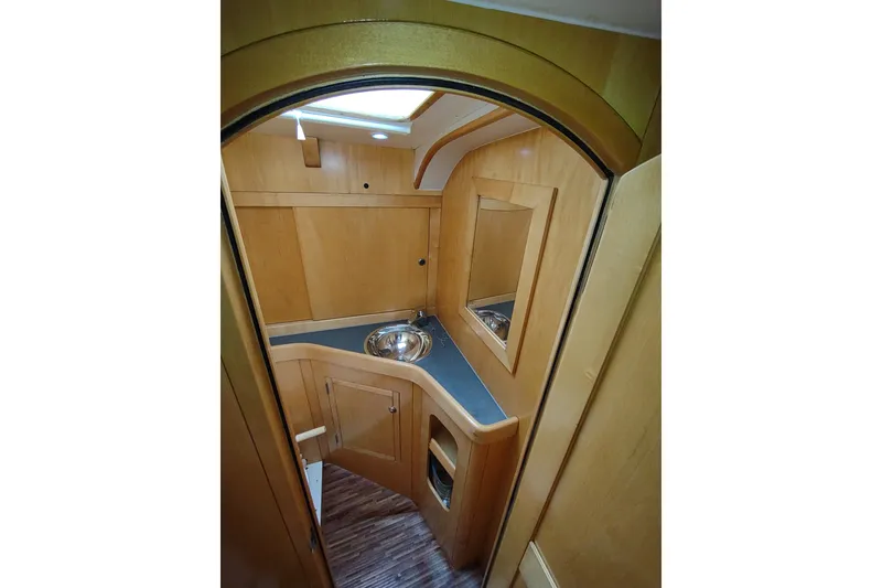 Slide: The Image of Interior of 2005 Garcia Passoa 47 yacht, featuring wooden cabinetry and compact sink area. - 34