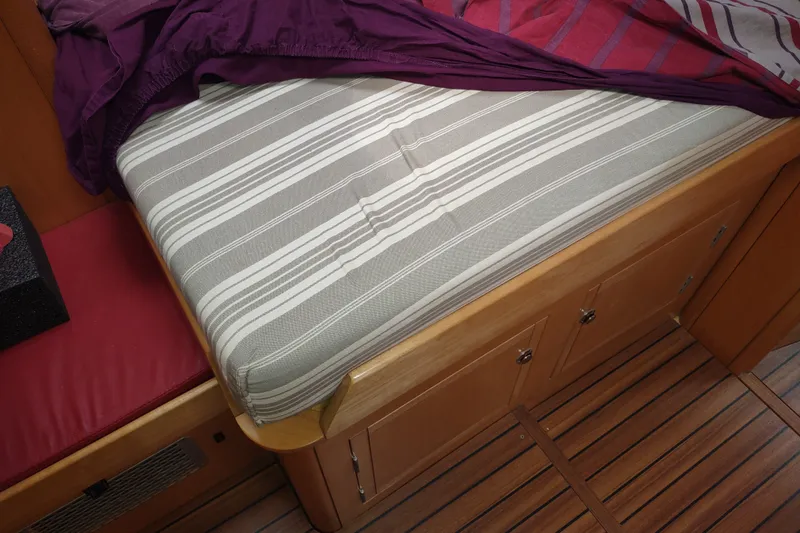 Slide: The Image of Interior of 2005 Garcia Passoa 47 yacht with striped mattress and wooden flooring. - 77