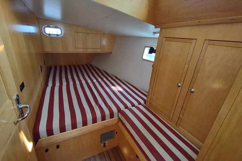 Slide: The Image of Cozy cabin interior of 2005 Garcia Passoa 47 yacht with striped bedding. - 22
