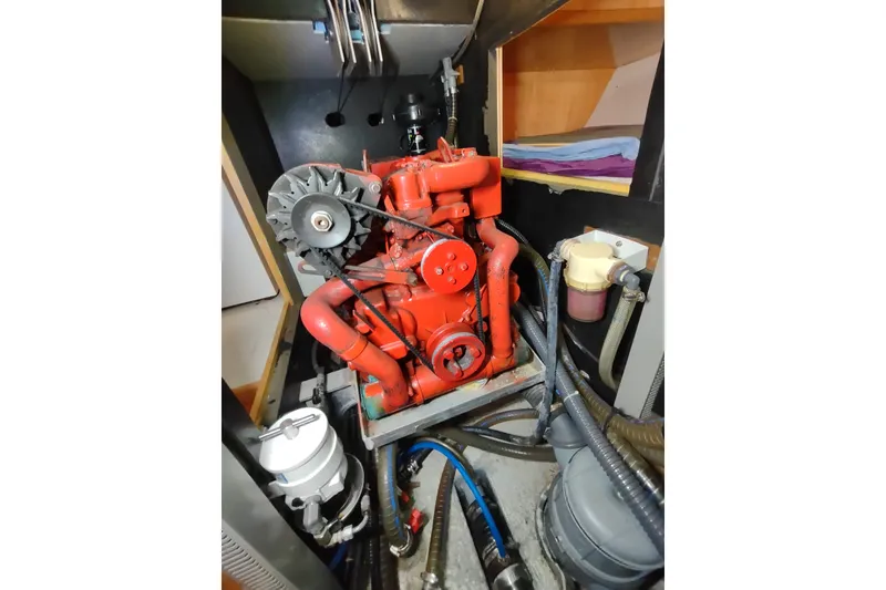 Slide: The Image of Engine compartment of a 2005 Garcia Passoa 47 sailboat, featuring a red engine. - 69