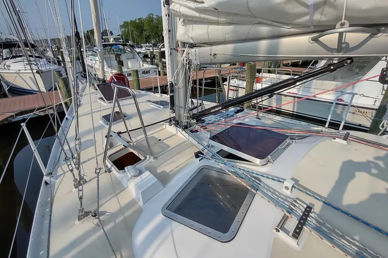 Slide: The Image of Deck view of 2005 Garcia Passoa 47 sailboat, showcasing rigging and hatches at marina. - 50