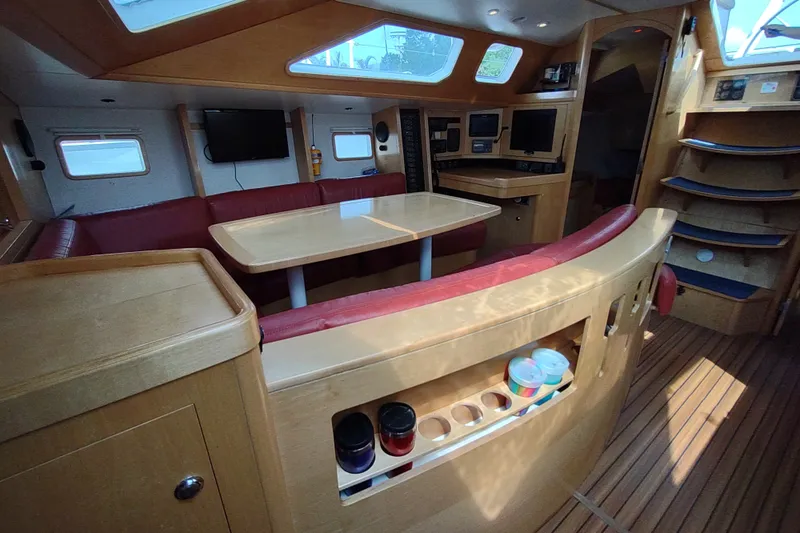 Slide: The Image of Interior of 2005 Garcia Passoa 47 yacht with wooden furnishings and red seating. - 16