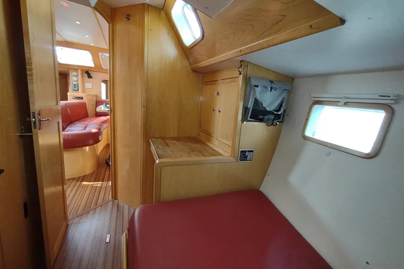 Slide: The Image of Interior of 2005 Garcia Passoa 47 yacht with wooden finish and red seating. - 20