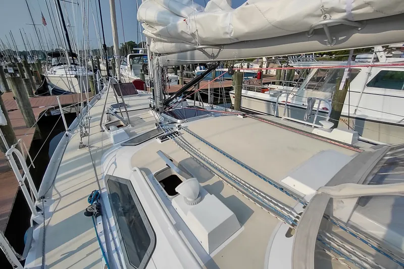 Slide: The Image of Sailboat Garcia Passoa 47, 2005 model, docked at a marina with other boats. - 49