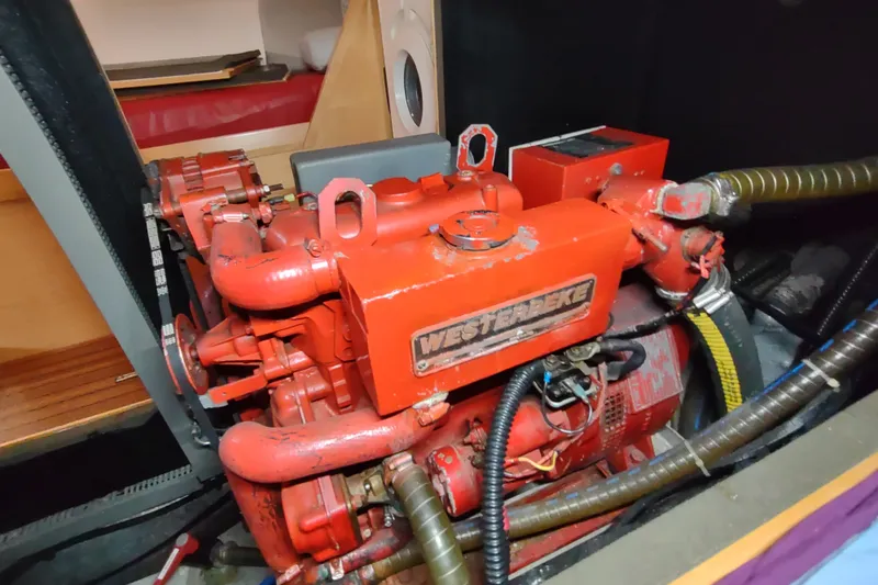 Slide: The Image of Engine compartment of a 2005 Garcia Passoa 47 yacht, featuring a red Westerbeke engine. - 64