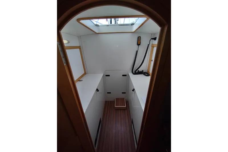 Slide: The Image of Interior of 2005 Garcia Passoa 47 sailboat, featuring a compact, well-lit cabin space. - 28