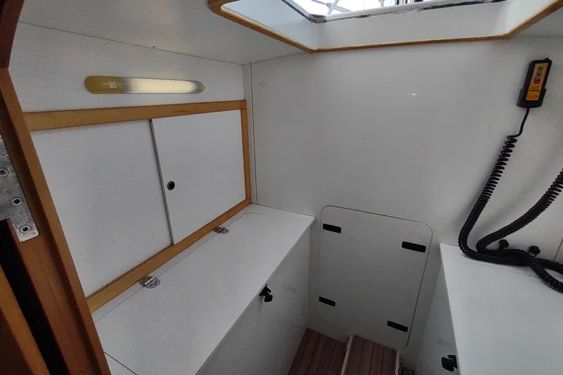Slide: The Image of Interior of 2005 Garcia Passoa 47 yacht with white cabinetry and communication device. - 26