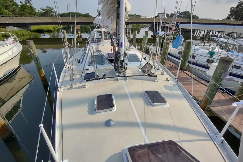 Slide: The Image of Sailboat Garcia Passoa 47, 2005 model, docked at a marina with clear skies. - 55