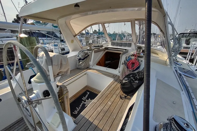 Slide: The Image of Cockpit of 2005 Garcia Passoa 47 sailboat with wooden deck and steering wheel. - 61