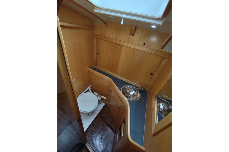 Slide: The Image of Interior of 2005 Garcia Passoa 47 yacht bathroom with wooden cabinetry and compact design. - 35