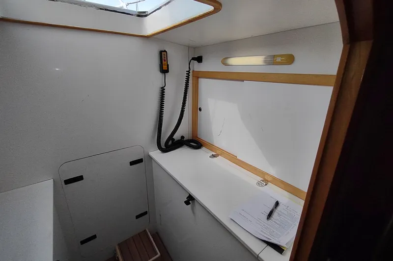Slide: The Image of Interior of 2005 Garcia Passoa 47 yacht with navigation equipment and documents. - 27