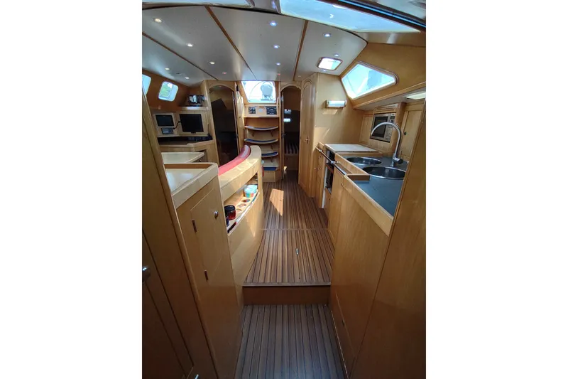 Slide: The Image of Interior of 2005 Garcia Passoa 47 yacht, featuring modern kitchen and wooden flooring. - 18