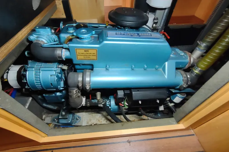 Slide: The Image of Engine compartment of a 2005 Garcia Passoa 47 sailboat, featuring a Perkins marine engine. - 62