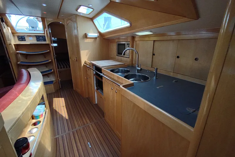 Slide: The Image of Interior of 2005 Garcia Passoa 47 yacht with modern kitchen and wooden finishes. - 17