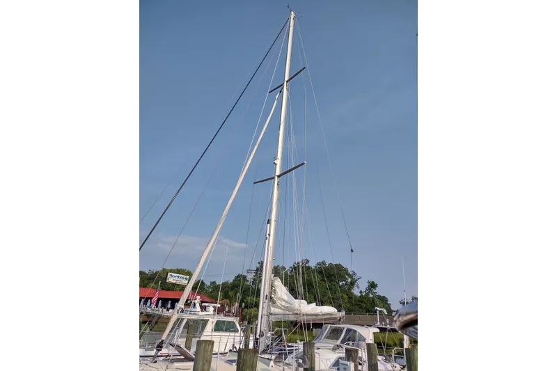 Slide: The Image of Sailboat Garcia Passoa 47, 2005 model, docked with mast and rigging visible. - 40