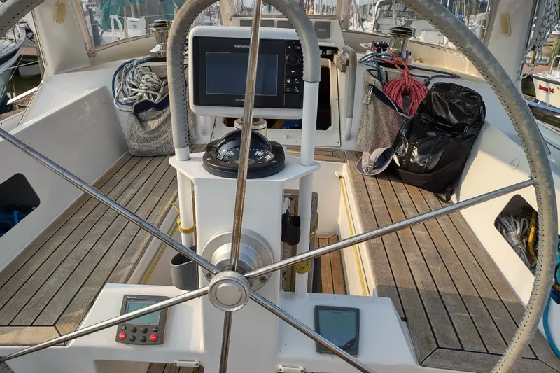 Slide: The Image of Cockpit of 2005 Garcia Passoa 47 sailboat with steering wheel and navigation equipment. - 41