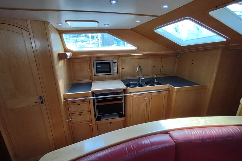 Slide: The Image of Interior of 2005 Garcia Passoa 47 yacht kitchen with wood cabinetry and modern appliances. - 14