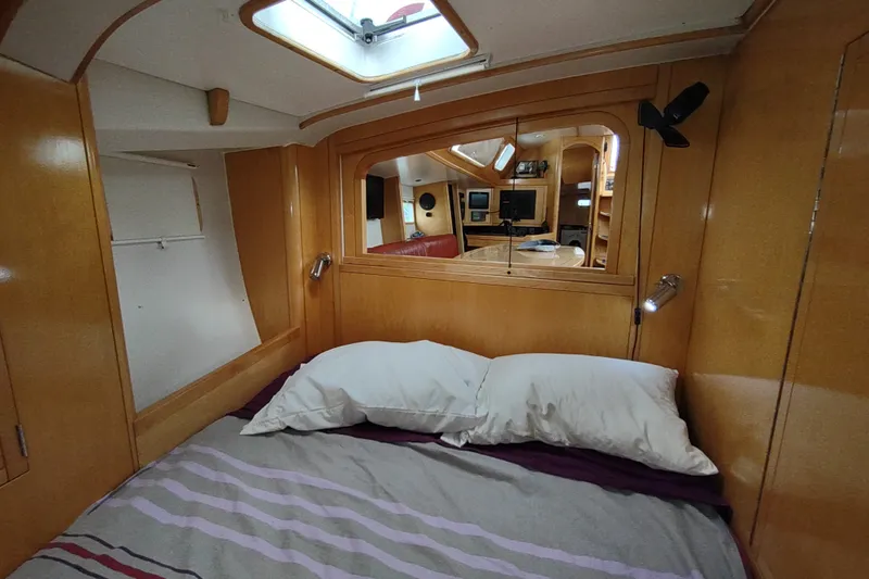 Slide: The Image of Cozy cabin interior of 2005 Garcia Passoa 47 yacht with wooden finish and comfortable bedding. - 32