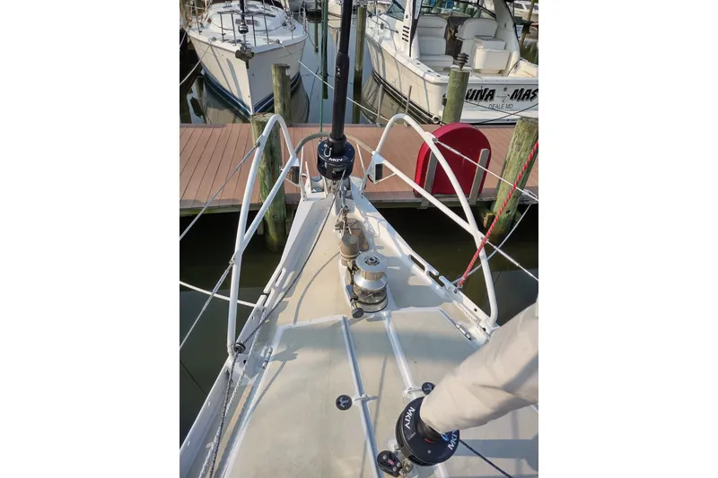 Slide: The Image of Deck view of a 2005 Garcia Passoa 47 sailboat docked at a marina. - 52