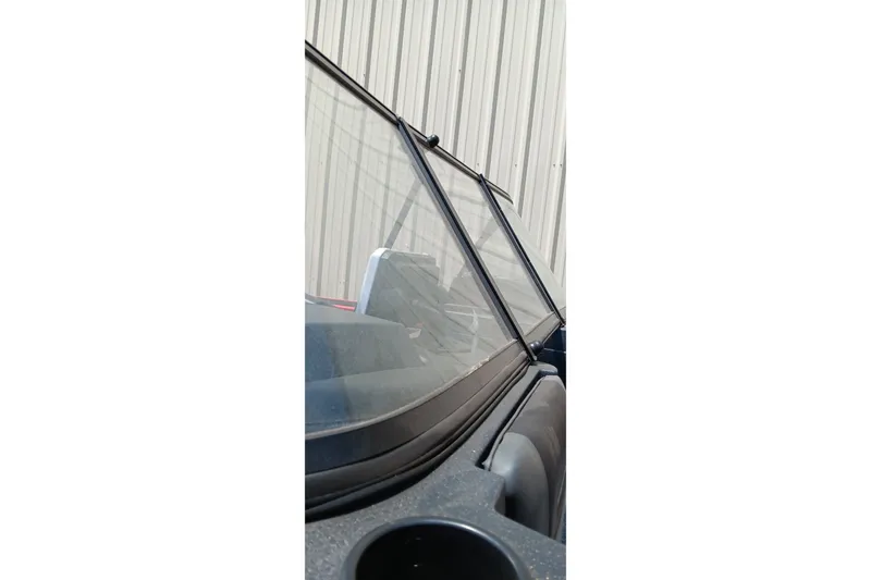 Slide: The Image of 2026 Tracker Targa V-18 Combo boat windshield close-up against a corrugated metal wall. - 12