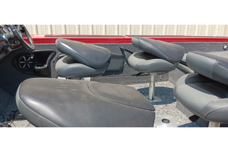 Slide: The Image of 2026 Tracker Targa V-18 Combo boat interior with gray seating and steering wheel. - 18