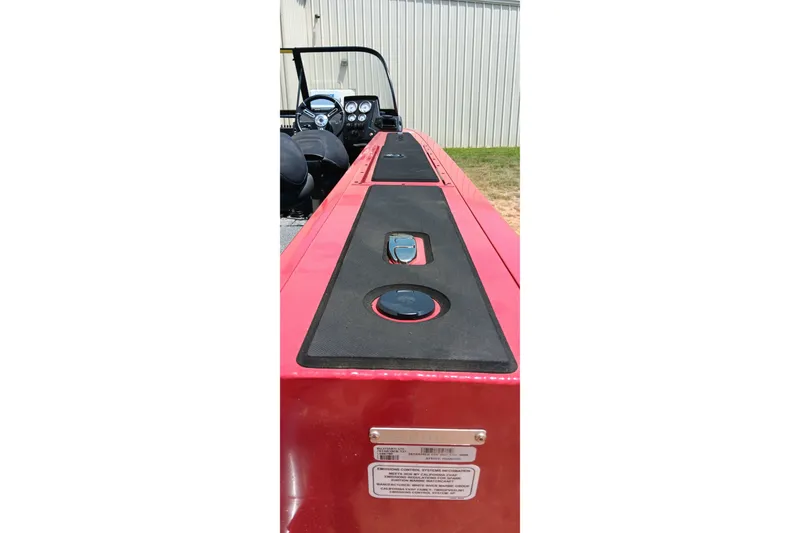 Slide: The Image of 2026 Tracker Targa V-18 Combo boat interior with red and black dashboard. - 8