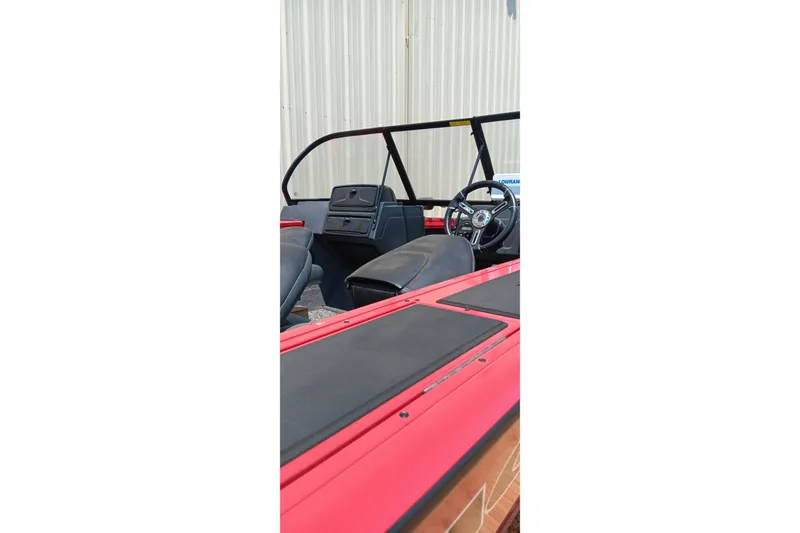 Slide: The Image of 2026 Tracker Targa V-18 Combo boat interior with steering wheel and seating. - 10