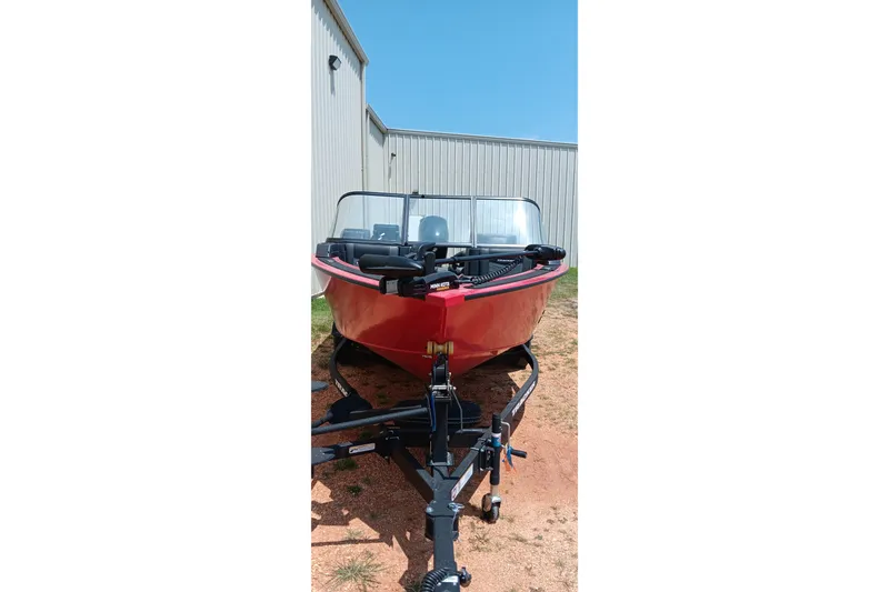 Slide: The Image of 2026 Tracker Targa V-18 Combo boat on trailer, parked outdoors. - 14