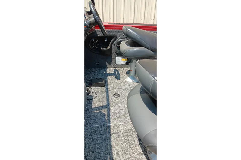 Slide: The Image of 2026 Tracker Targa V-18 Combo boat interior with steering wheel and seating. - 21