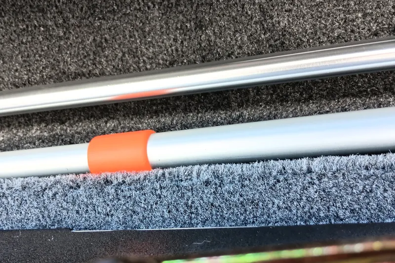 Slide: The Image of Close-up of Tracker Targa V-18 Combo 2026 boat interior with metal rods and orange detail. - 20
