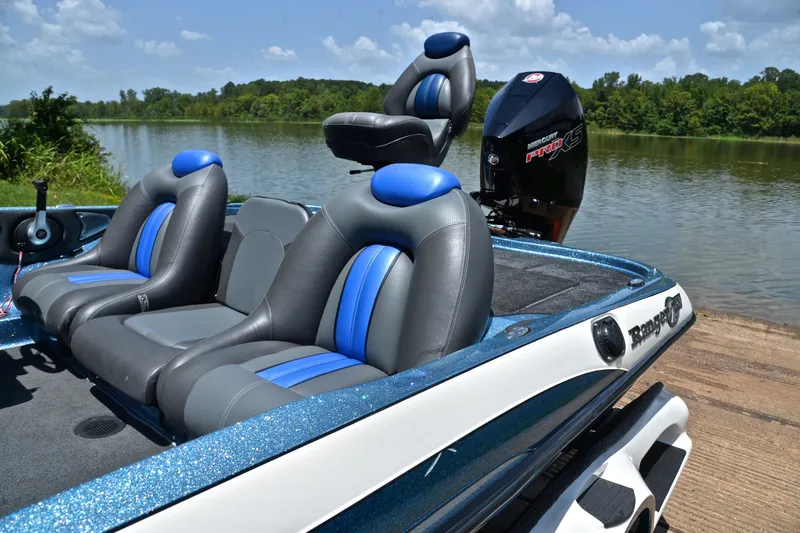 Slide: The Image of 2012 Ranger Z518 boat with blue seats by a serene lake. - 18