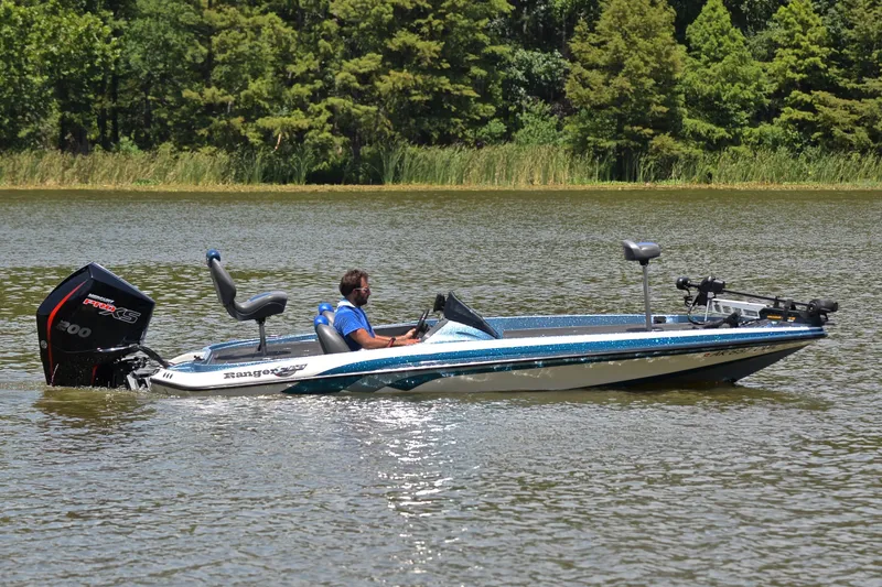 Slide: The Image of 2012 Ranger Z518 boat on a lake, with trees in the background. - 7