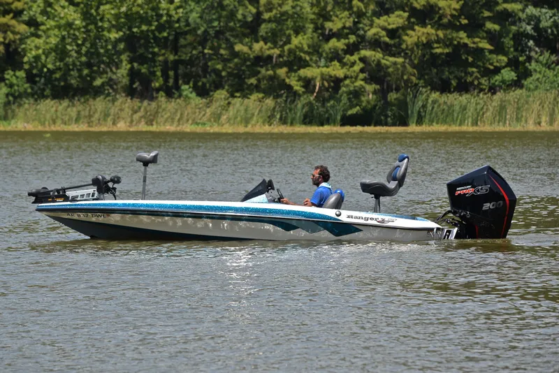 Slide: The Image of 2012 Ranger Z518 boat on a lake, featuring a powerful Mercury Pro XS engine. - 9