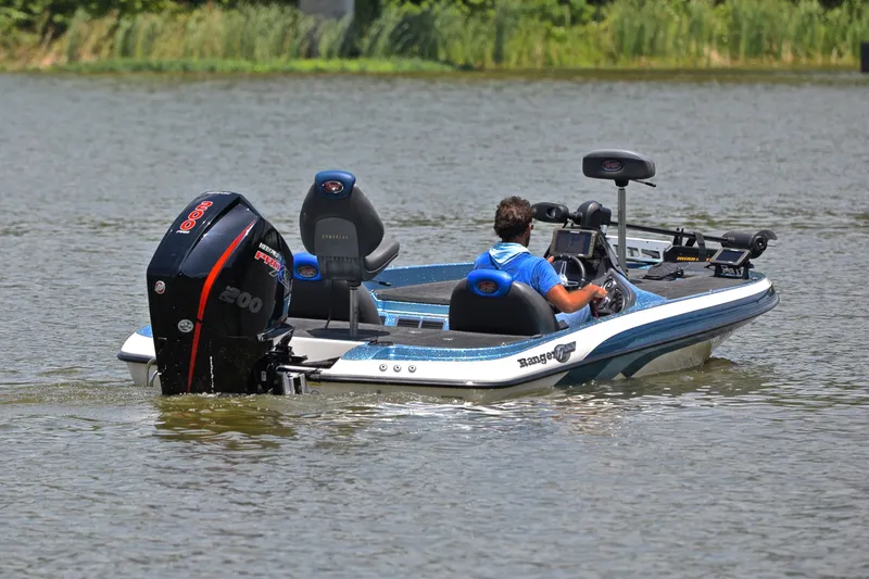Slide: The Image of 2012 Ranger Z518 boat on a lake, featuring a powerful outboard motor. - 8
