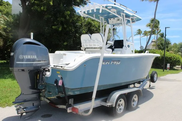 Slide: The Image of A 2023 Sea Pro 219 Center Console boat on a trailer, featuring a Yamaha outboard motor. - 8