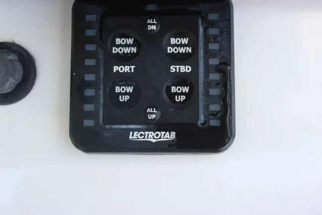 Slide: The Image of A trim tab control panel with various buttons for up and down movements. - 40