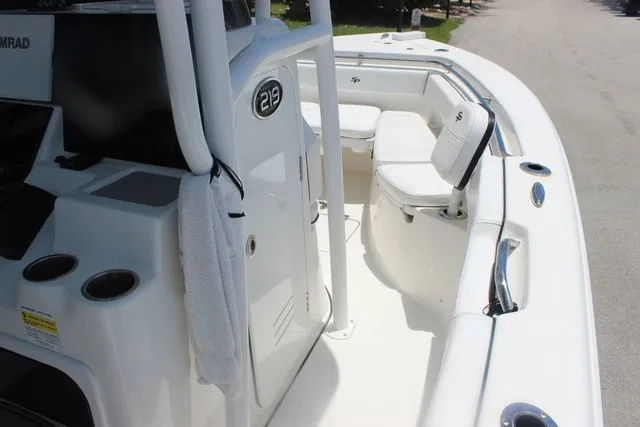 Slide: The Image of The image shows the cockpit of a 2023 Sea Pro 219 Center Console boat with white seating. - 17
