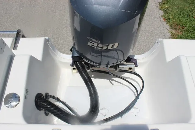 Slide: The Image of A Yamaha 250 outboard motor is mounted on a white boat. Cables are neatly arranged. - 46